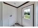 Laundry room with white door and gray flooring at 10109 Old Spanish Trl, Polk City, FL 33868