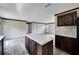 Kitchen island with light countertop and dark wood cabinets at 10109 Old Spanish Trl, Polk City, FL 33868