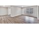 Living room featuring wood-look floors, a window, and interior access at 905 14Th Ne St, Winter Haven, FL 33881