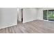 Bright living room with wood-look floors and sliding glass doors leading to a patio at 905 14Th Ne St, Winter Haven, FL 33881