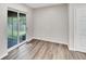 Dining area with wood-look floors and access to a backyard patio at 905 14Th Ne St, Winter Haven, FL 33881