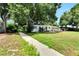 Ranch style home with a large front yard and walkway at 905 14Th Ne St, Winter Haven, FL 33881