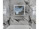 Bright bathroom with marble shower/tub surround and window at 905 14Th Ne St, Winter Haven, FL 33881