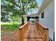 Wooden ramp leading to back porch with screened enclosure at 905 14Th Ne St, Winter Haven, FL 33881