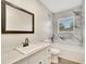 Updated bathroom features a marble shower/tub combo, modern vanity, and updated fixtures at 905 14Th Ne St, Winter Haven, FL 33881