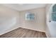 Small bedroom with wood-look floors and window at 905 14Th Ne St, Winter Haven, FL 33881