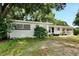 Side view of a white Ranch home with landscaping at 905 14Th Ne St, Winter Haven, FL 33881