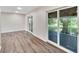 Bright dining room with wood-look floors and two sets of sliding glass doors at 905 14Th Ne St, Winter Haven, FL 33881