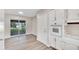 Updated kitchen with white cabinets, new flooring and a view to the backyard at 905 14Th Ne St, Winter Haven, FL 33881