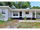 Front of house with covered porch and landscaping at 905 14Th Ne St, Winter Haven, FL 33881