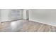 Living room with wood-look floors, window, and an interior door at 905 14Th Ne St, Winter Haven, FL 33881