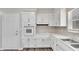 L-shaped kitchen with white cabinets, updated appliances, and ample counter space at 905 14Th Ne St, Winter Haven, FL 33881