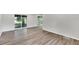 Light-filled living room with wood-look floors and sliding glass doors at 905 14Th Ne St, Winter Haven, FL 33881
