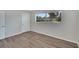 Bedroom with wood-look floors, window, and closet at 905 14Th Ne St, Winter Haven, FL 33881