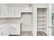 Kitchen features white cabinets, a walk-in pantry, and updated flooring at 905 14Th Ne St, Winter Haven, FL 33881