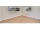 Well-lit bedroom with wood-look floors and large windows at 905 14Th Ne St, Winter Haven, FL 33881