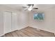 Spacious bedroom with wood-look floors, ceiling fan, and large closet at 905 14Th Ne St, Winter Haven, FL 33881