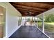 Spacious screened porch with ceiling fan and dark flooring at 905 14Th Ne St, Winter Haven, FL 33881