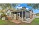 Home exterior showcasing a screened porch and backyard at 1295 E Georgia St, Bartow, FL 33830