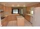 Kitchen features light wood cabinets, tile floors and breakfast bar at 2418 Berkshire Dr, Winter Haven, FL 33884