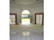 Bright living room with French doors opening to a pool view at 2418 Berkshire Dr, Winter Haven, FL 33884