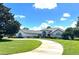 Two-story home with red door and circular driveway at 2418 Berkshire Dr, Winter Haven, FL 33884