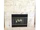 Close-up of a stone fireplace with a black metal screen at 2418 Berkshire Dr, Winter Haven, FL 33884