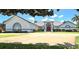 Two-story home with red door and large driveway at 2418 Berkshire Dr, Winter Haven, FL 33884