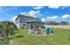 Spacious backyard with firepit and view of two-story home at 411 Sunfish Dr, Winter Haven, FL 33881