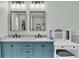Double vanity bathroom with blue cabinets and marble countertops at 411 Sunfish Dr, Winter Haven, FL 33881