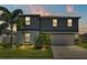 Two story gray house with landscaping and driveway at 411 Sunfish Dr, Winter Haven, FL 33881