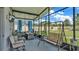 Relaxing screened patio with seating area, swing, and backyard access at 411 Sunfish Dr, Winter Haven, FL 33881