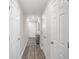 Light and airy hallway with neutral walls and wood-look flooring at 1254 Chester Ave, Haines City, FL 33844