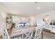Bright dining area with wooden table and white chairs, hardwood floors at 1258 Chester Ave, Haines City, FL 33844