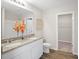 Bathroom with double vanity, granite countertop, and walk-in closet at 989 Ambleside Dr, Haines City, FL 33844
