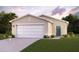 Two-car garage and front yard landscaping at 1021 Ambleside Dr, Haines City, FL 33844