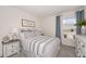 Charming bedroom with a full-size bed, striped bedding and a window with natural light at 1021 Ambleside Dr, Haines City, FL 33844