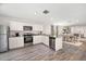 Open concept kitchen with white cabinets and stainless steel appliances at 1021 Ambleside Dr, Haines City, FL 33844