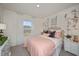 Cozy bedroom with floral wall art and a comfy bed with pink bedding at 1261 Chester Ave, Haines City, FL 33844