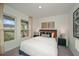 Well-lit bedroom with double windows and neutral-toned bedding at 1261 Chester Ave, Haines City, FL 33844