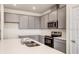 Modern kitchen with gray cabinets, stainless steel appliances, and an island at 2350 Selenia St, Lake Alfred, FL 33850