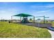 Community playground with shaded playset and swings at 2350 Selenia St, Lake Alfred, FL 33850