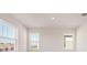 Bright living room featuring large windows and neutral walls at 2350 Selenia St, Lake Alfred, FL 33850