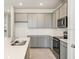 Modern kitchen features gray cabinets, stainless steel appliances, and a large island at 2350 Selenia St, Lake Alfred, FL 33850