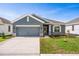 Two-car garage, gray exterior home with stone accents at 2350 Selenia St, Lake Alfred, FL 33850