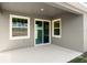 Covered patio with sliding glass doors and gray walls at 2551 Mariah Pl, Lake Alfred, FL 33850