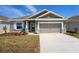 New construction home with gray siding and stone accents at 2551 Mariah Pl, Lake Alfred, FL 33850