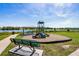 Community playground with a gazebo and benches near a lake at 2355 Selenia St, Lake Alfred, FL 33850