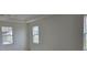 Bright bedroom with neutral walls and two large windows at 2561 Mariah Pl, Lake Alfred, FL 33850