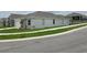 Side view of a single-Gathering house with landscaping and a curved sidewalk at 2561 Mariah Pl, Lake Alfred, FL 33850